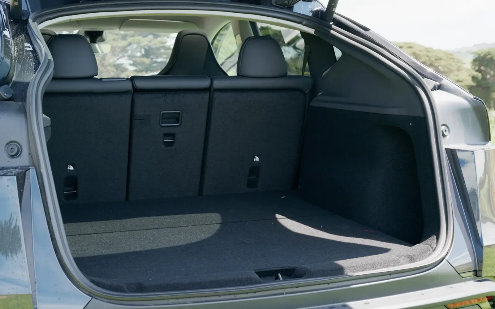 Open rear trunk of the Tesla Model Y showing a deep and wide cargo area.