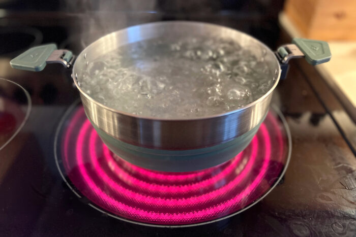 A Sea to Summit Detour pot showing its stainless steel base designed for induction and gas stoves.