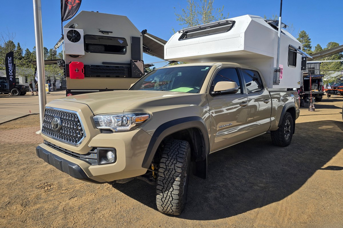 An AT Overland Aterra ASI slide-in camper mounted on the bed of a Toyota Tacoma.
