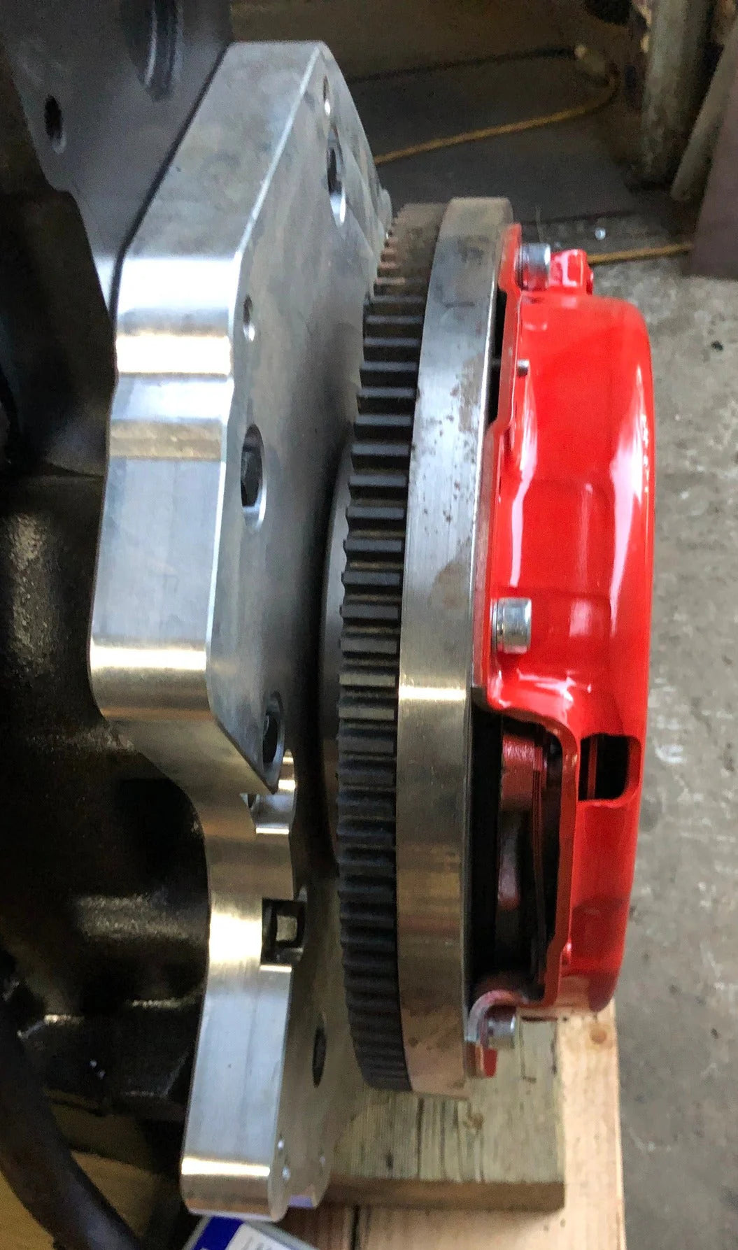 A high-precision CNC-machined aluminum adapter plate for a vehicle drivetrain.