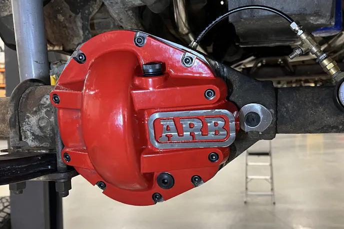 Underside view of the Jeep J10 drivetrain showing the transmission and Dana 300 transfer case.
