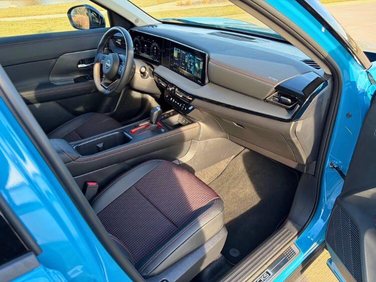 Interior view of the passenger side dashboard and soft-touch points in the 2026 Nissan Kicks.