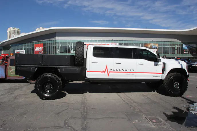 Custom aluminum tray bed with integrated storage boxes and L-Track mounting rails.