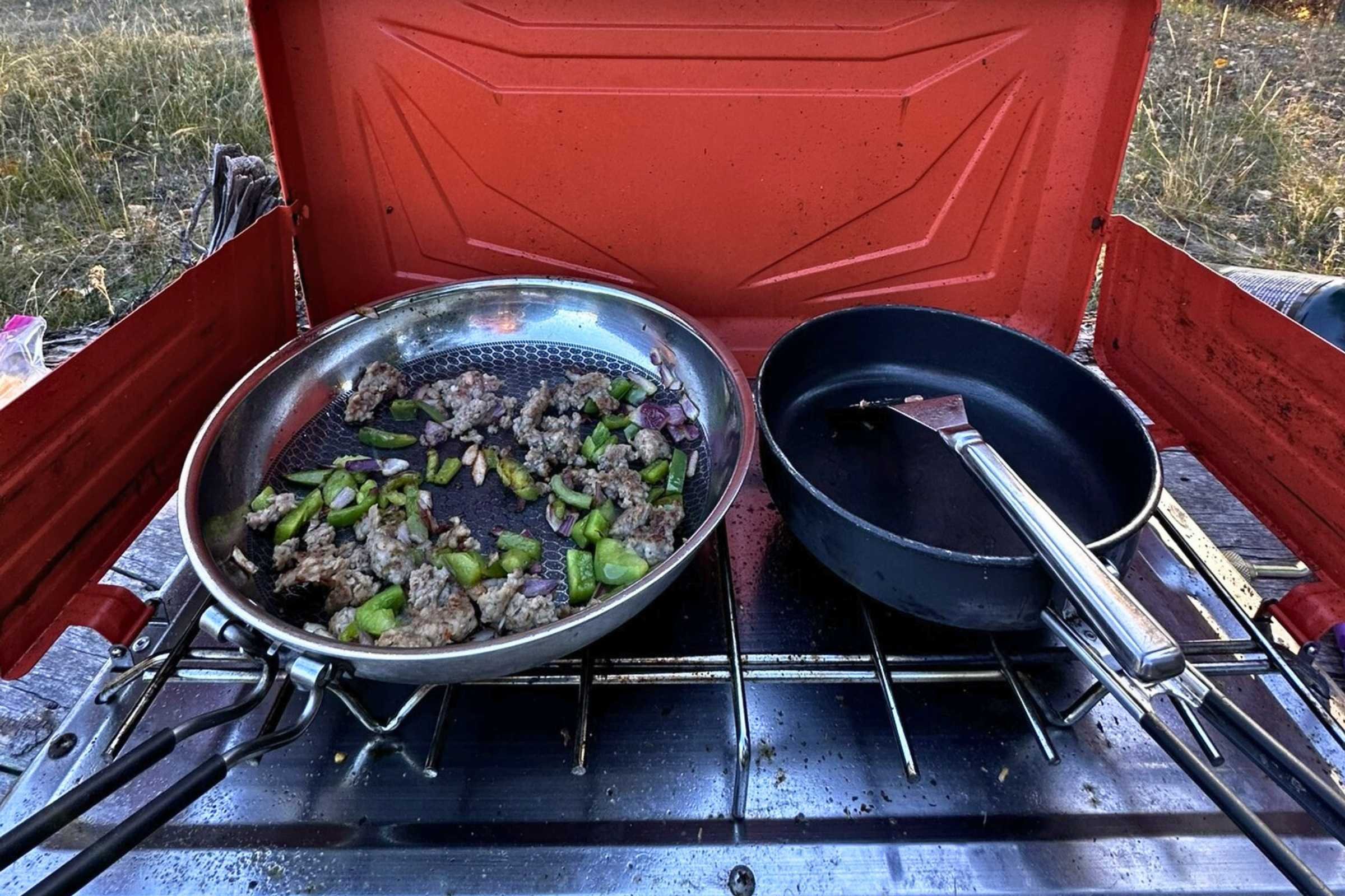 Close up of colorful fajitas cooking on a high-output camping stove burner.