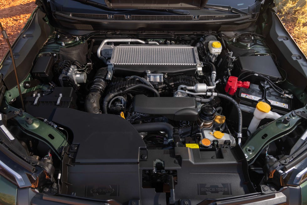 A 2026 Subaru Outback driving through a scenic outdoor environment