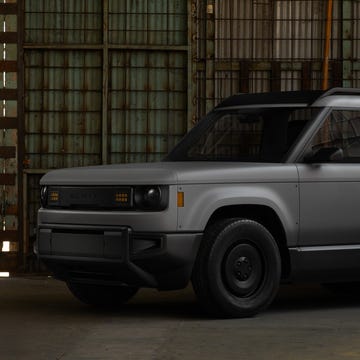 A heavy-duty slate-colored truck representing industrial manufacturing and logistics.