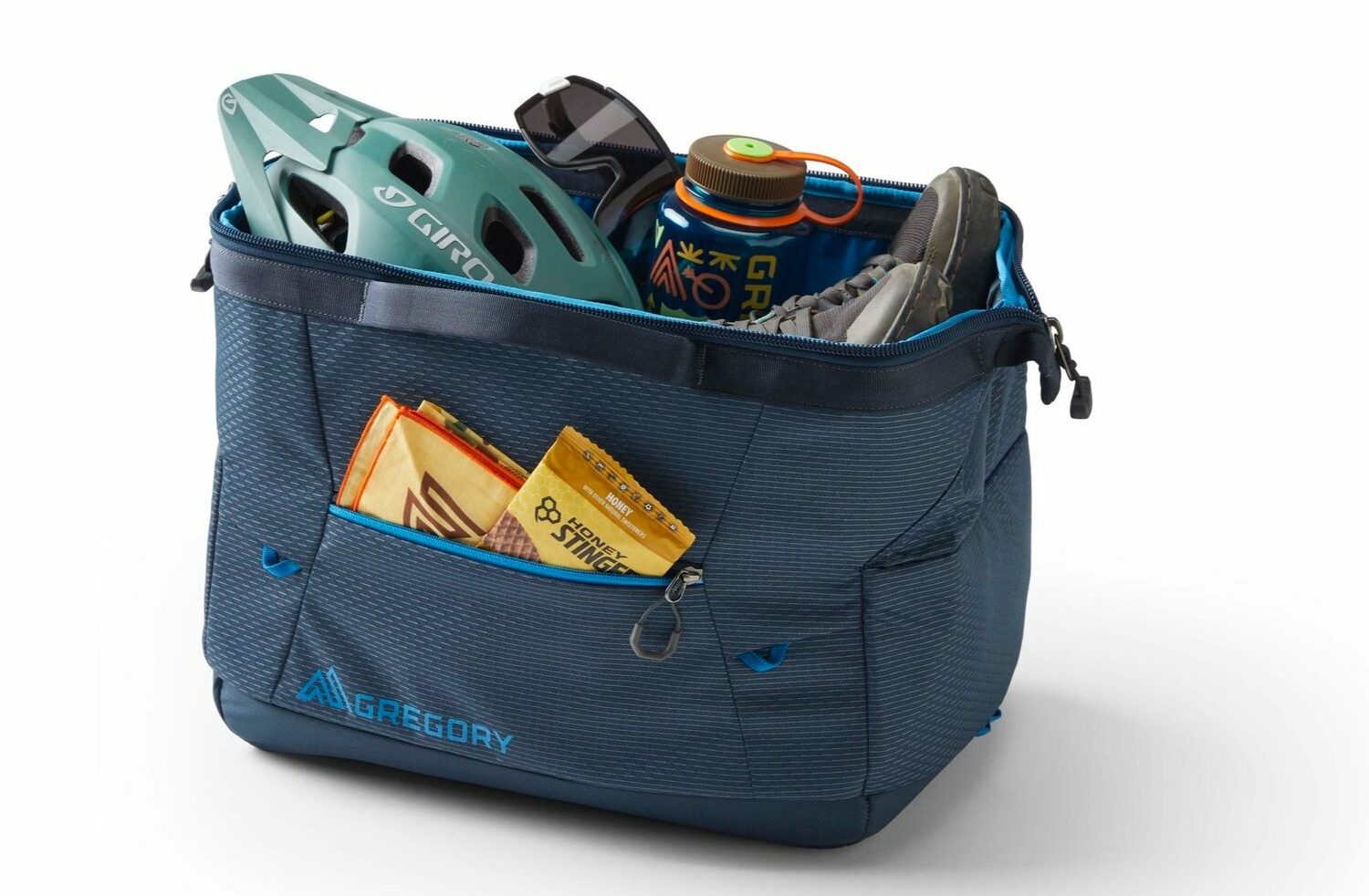 A slate blue Gregory Alpaca Wide Mouth duffel with its top open.
