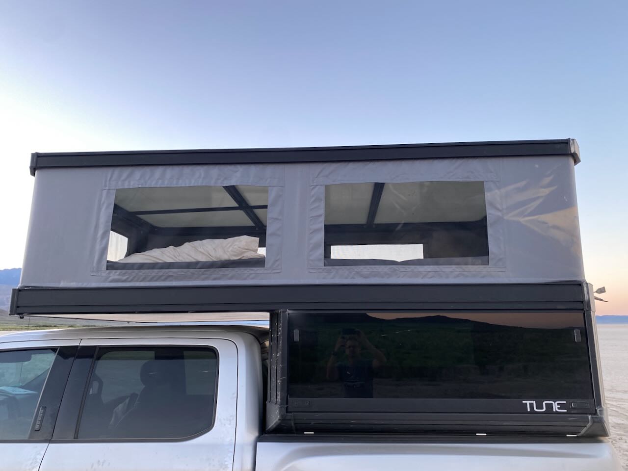 Wide interior view of the flagship Tune M1 camper showing more expansive living space and glass panels.