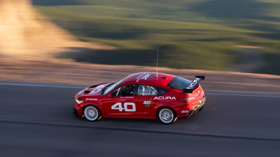 Integra Type S DE5 race car in motion on a steep mountain pass.