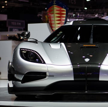A silver Koenigsegg One:1 hypercar parked on a track.