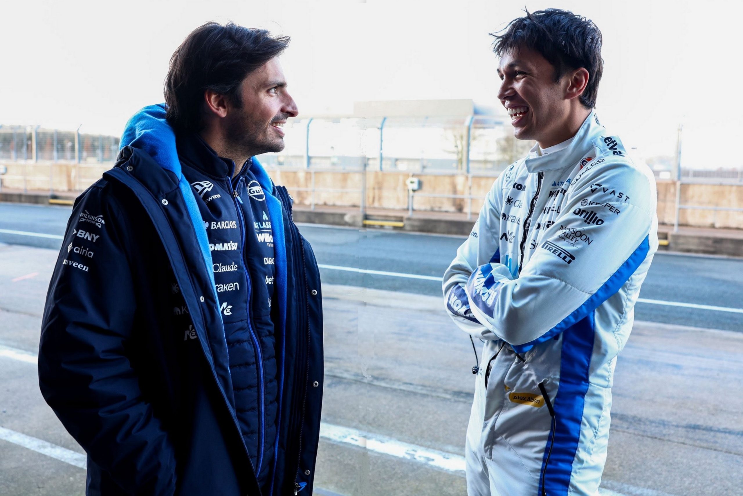 Williams F1 mechanics and engineers working around the FW48 in the garage area.