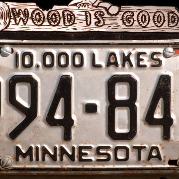 Vintage collector car license plate on a classic vehicle.