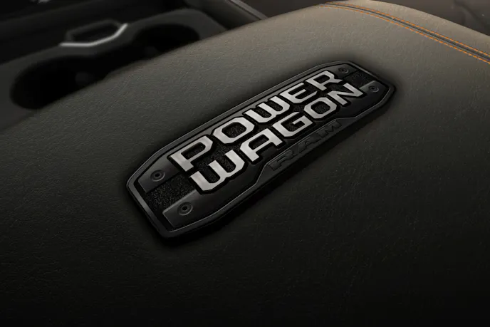 Close-up of the Ram 2500 Lunar Edition interior showing black leather seats and Copperhead Orange stitching.