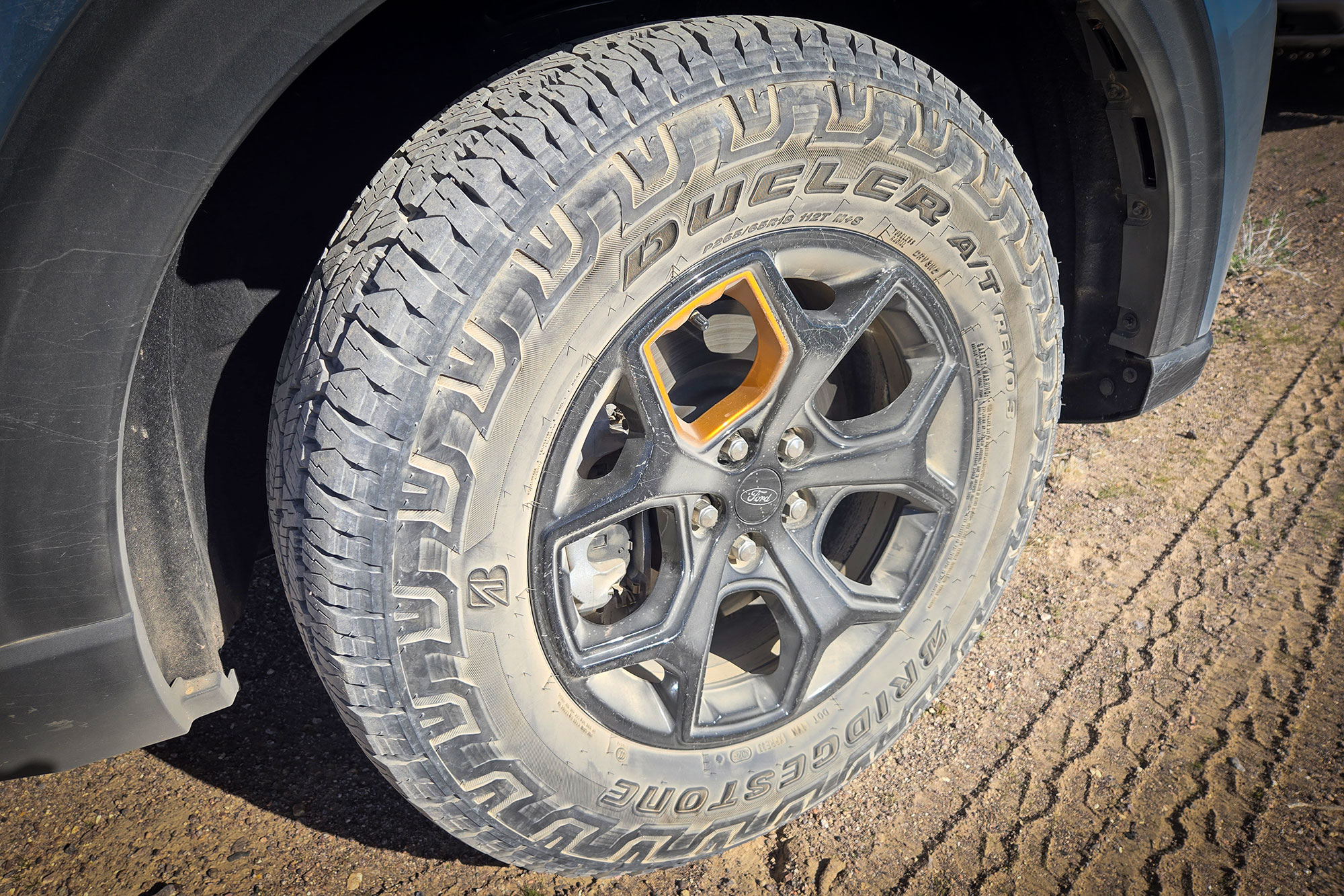 Close-up of the 18-inch black wheel and Bridgestone Dueler all-terrain tire on the Explorer Tremor.