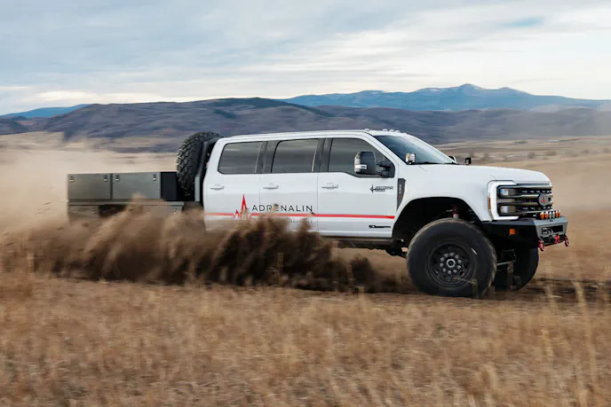 Rear perspective of the 2025 Ford F-550 Overkill Judgment showing its high ground clearance and custom bed.