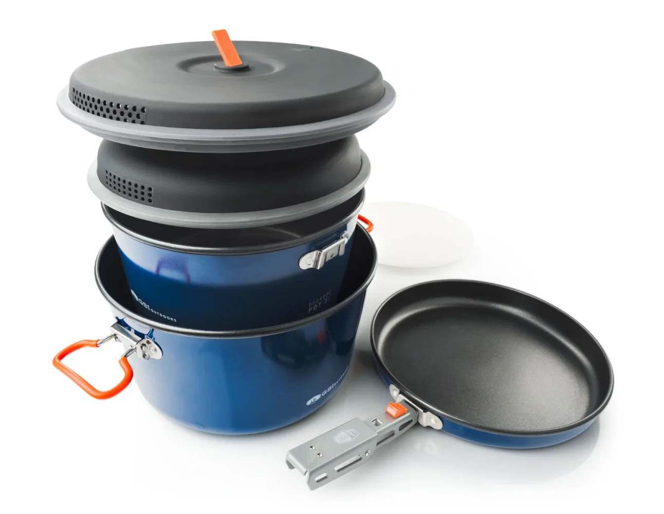A stacked GSI Bugaboo Ceramic Base Camper cookware set on a camping table.