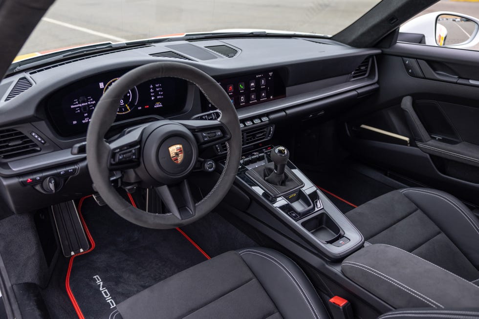Driver's perspective of the 2025 Porsche 911 GT3 dashboard and digital instrument cluster.