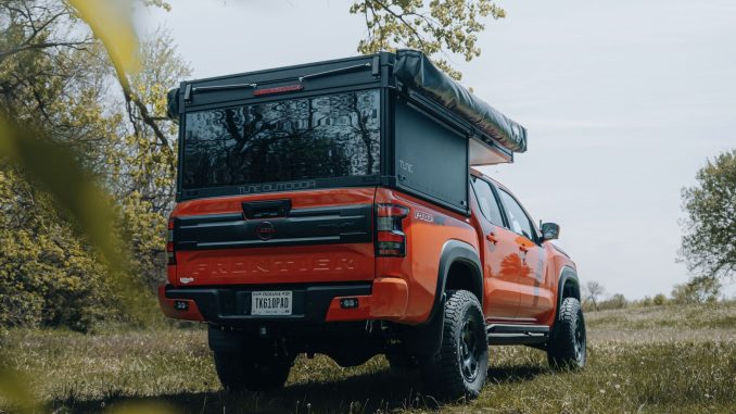 Rear view of the Ultimate Overland Build showing the Tune M1 topper open