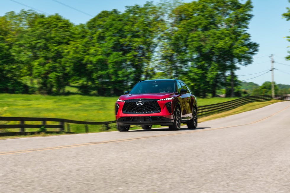 A 2027 Infiniti QX65 Autograph driving through a wooded area.