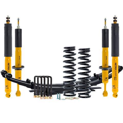 A close-up of a high-performance off-road coilover suspension system installed on a vehicle.