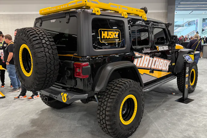 Rear three-quarter view of the Matchbox Jeep Wrangler showcasing the custom rack and off-road tires.