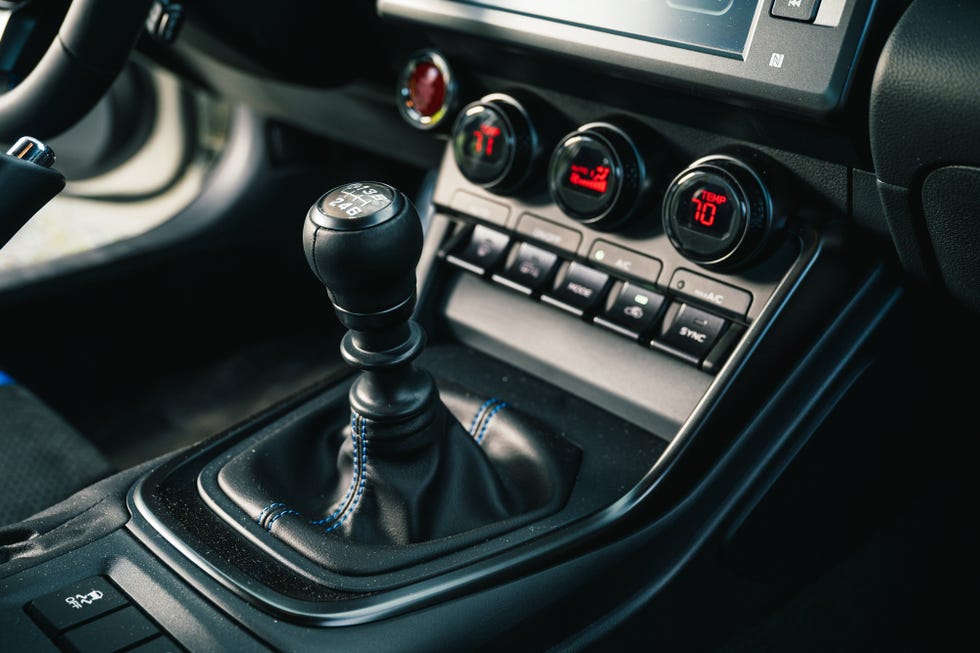 Close-up of the Subaru BRZ tS manual gear shifter and center console buttons.