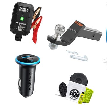 A collection of automotive sensors, tools, and accessories on a workbench.