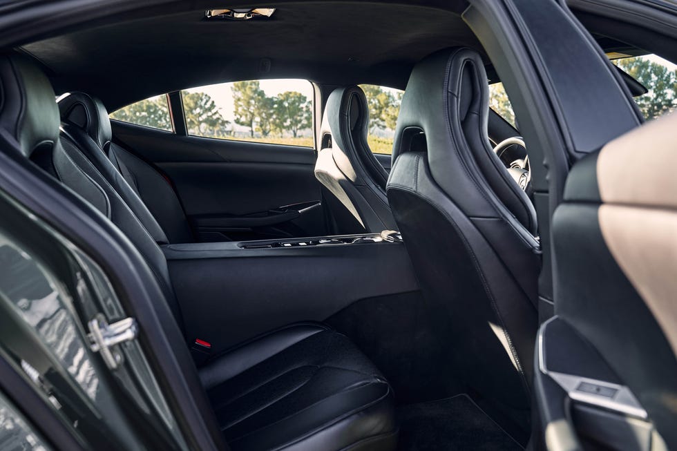 The cramped rear seating area of the Karma Revero with a large center console.
