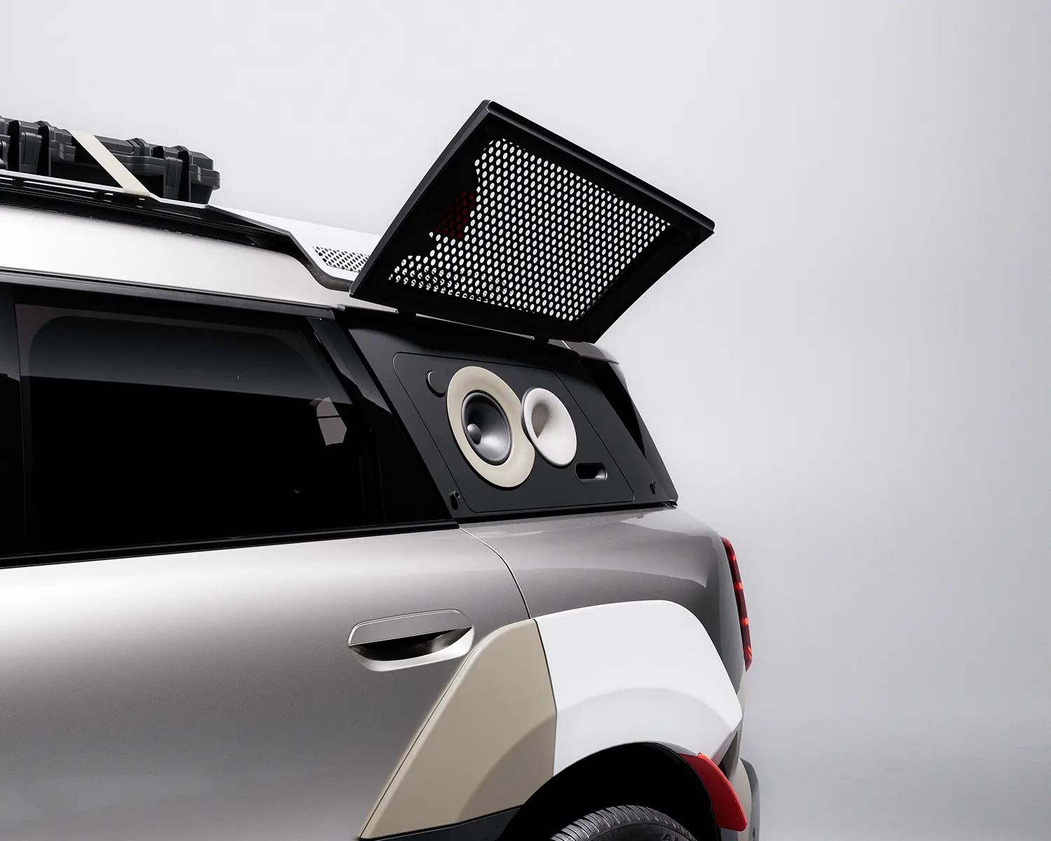 Exterior high-fidelity speakers integrated into the rear window panel of a silver MINI Countryman.
