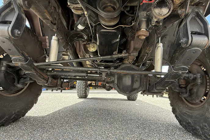 A clean view of an installed 406 cubic-inch AMC V8 engine with an Edelbrock carburetor.