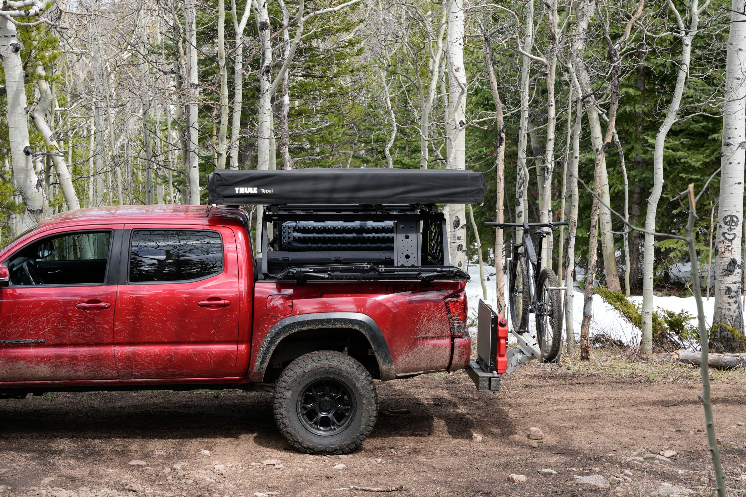 Side profile of a silver Leitner ACS Forged bed rack on a pickup truck.