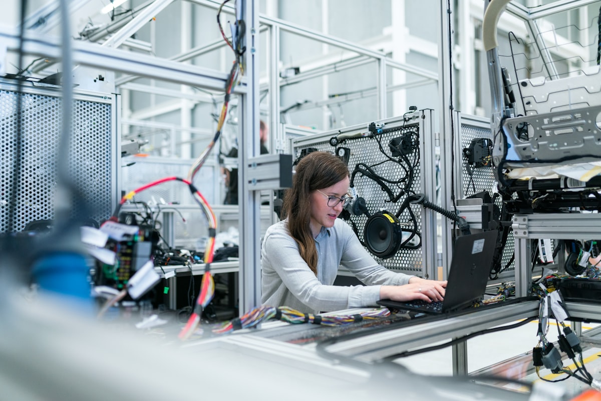 Industrial robotic arms working on the chassis of a car in an assembly plant