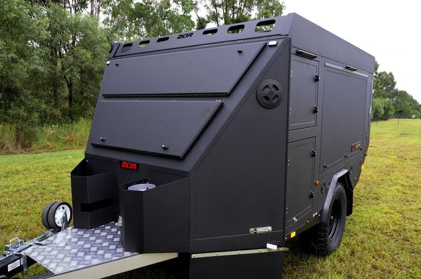 Australian Off Road Sierra ultra-light micro camper navigating a rocky path.
