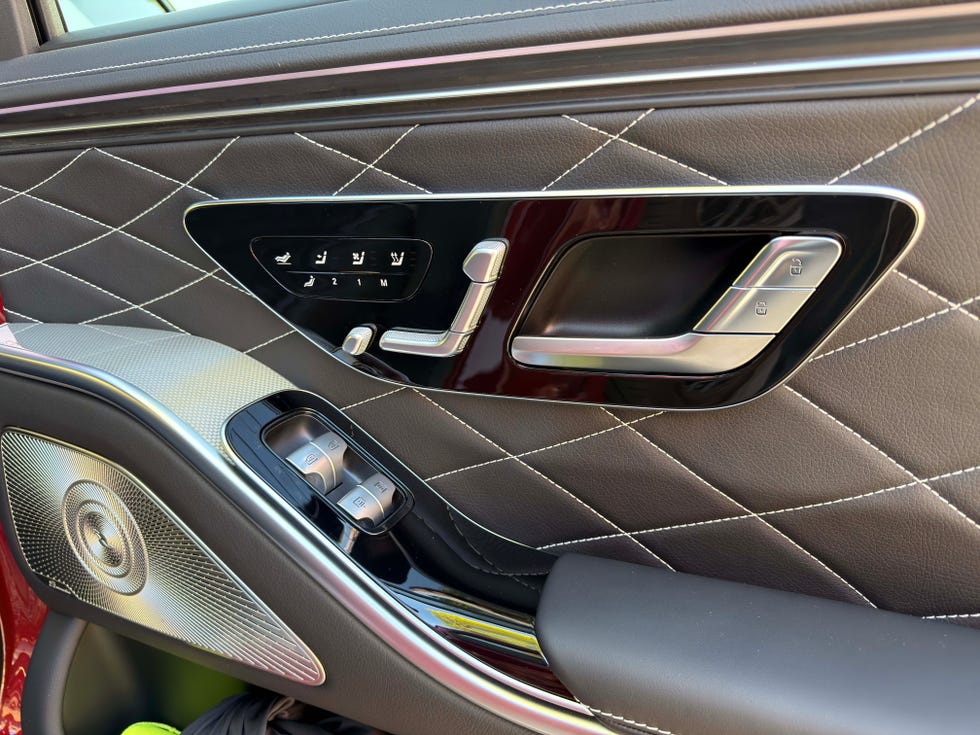 Detailed view of the Mercedes S-Class rear door controls for seat adjustment and heating.