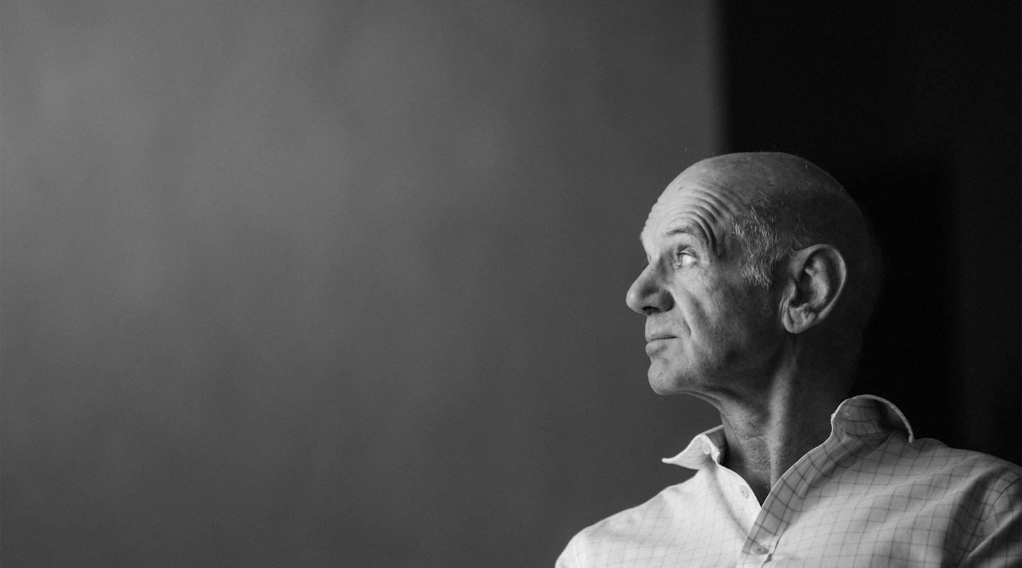 Black and white portrait of Adrian Newey during an interview.