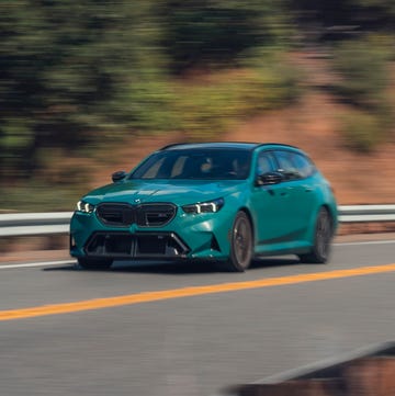 Rear view of a 2025 BMW M5 Touring, representing the shared technological lineage with Mini.