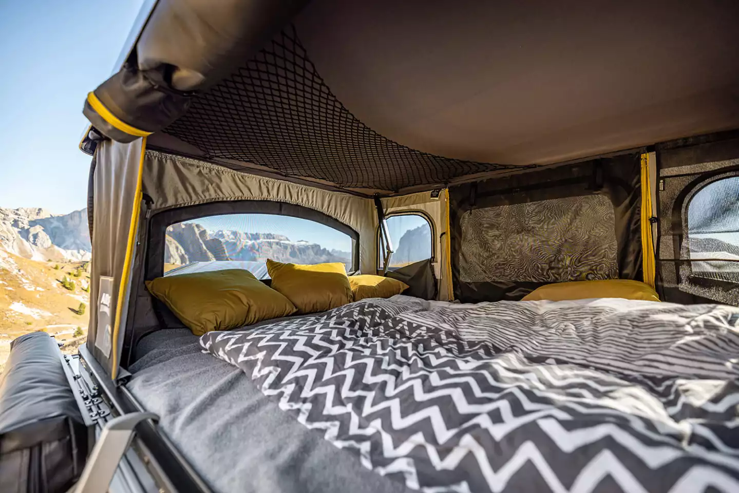Blackcamp Freeda trailer with an Airhome rooftop tent deployed in a field