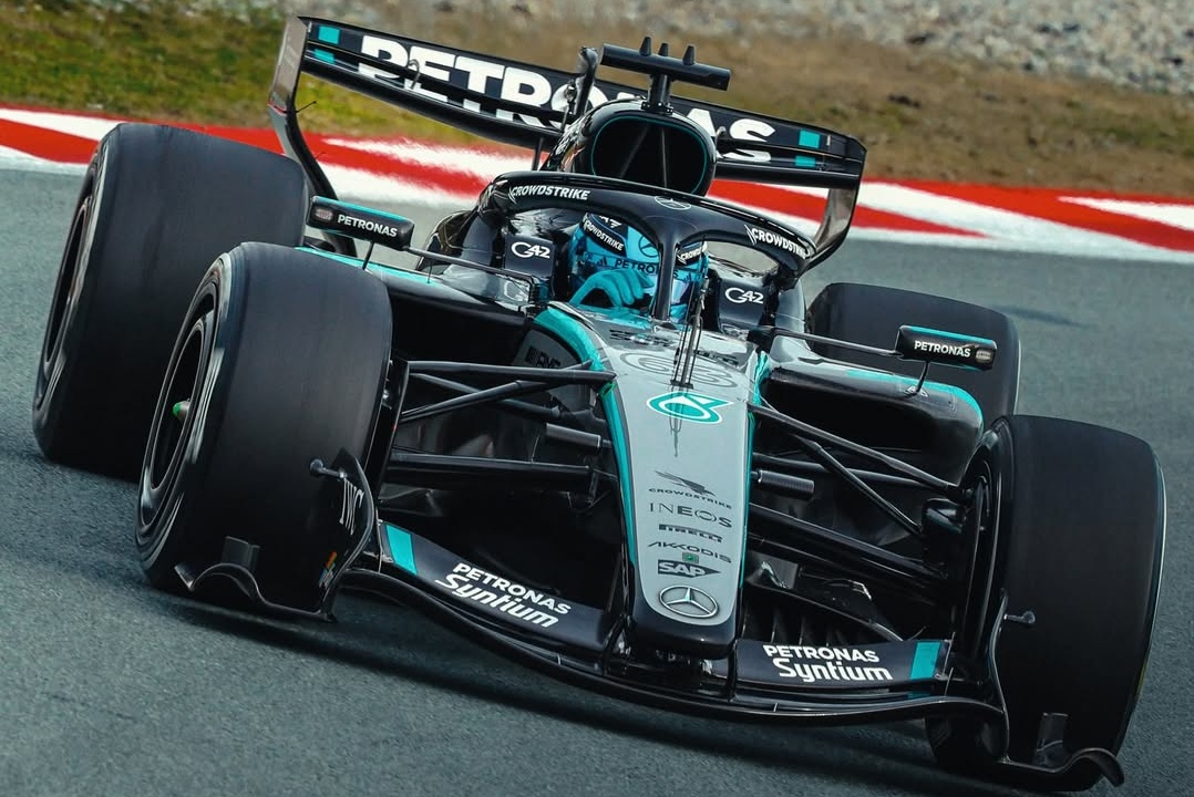 George Russell driving the silver Mercedes W17 on a race track during pre-season testing.
