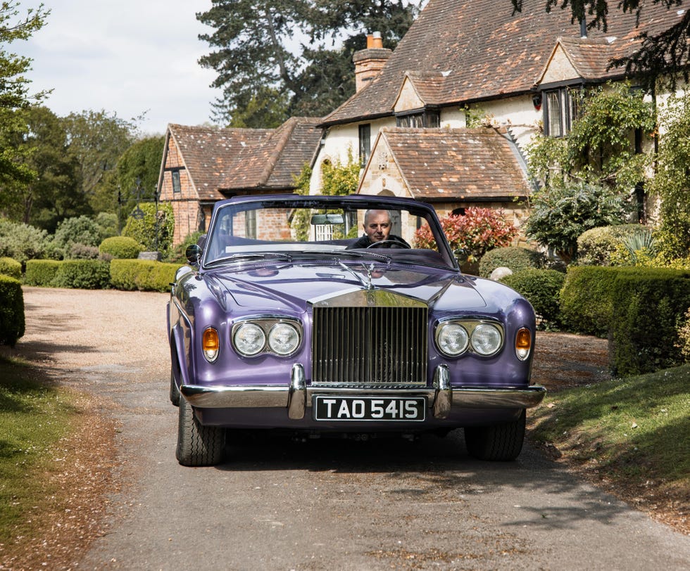 A white and silver Halcyon rolls royce corniche ev restomod parked in a scenic location.
