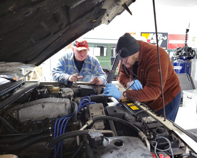 A close-up shot of a vehicle's undercarriage showing mechanical components and minor surface rust.