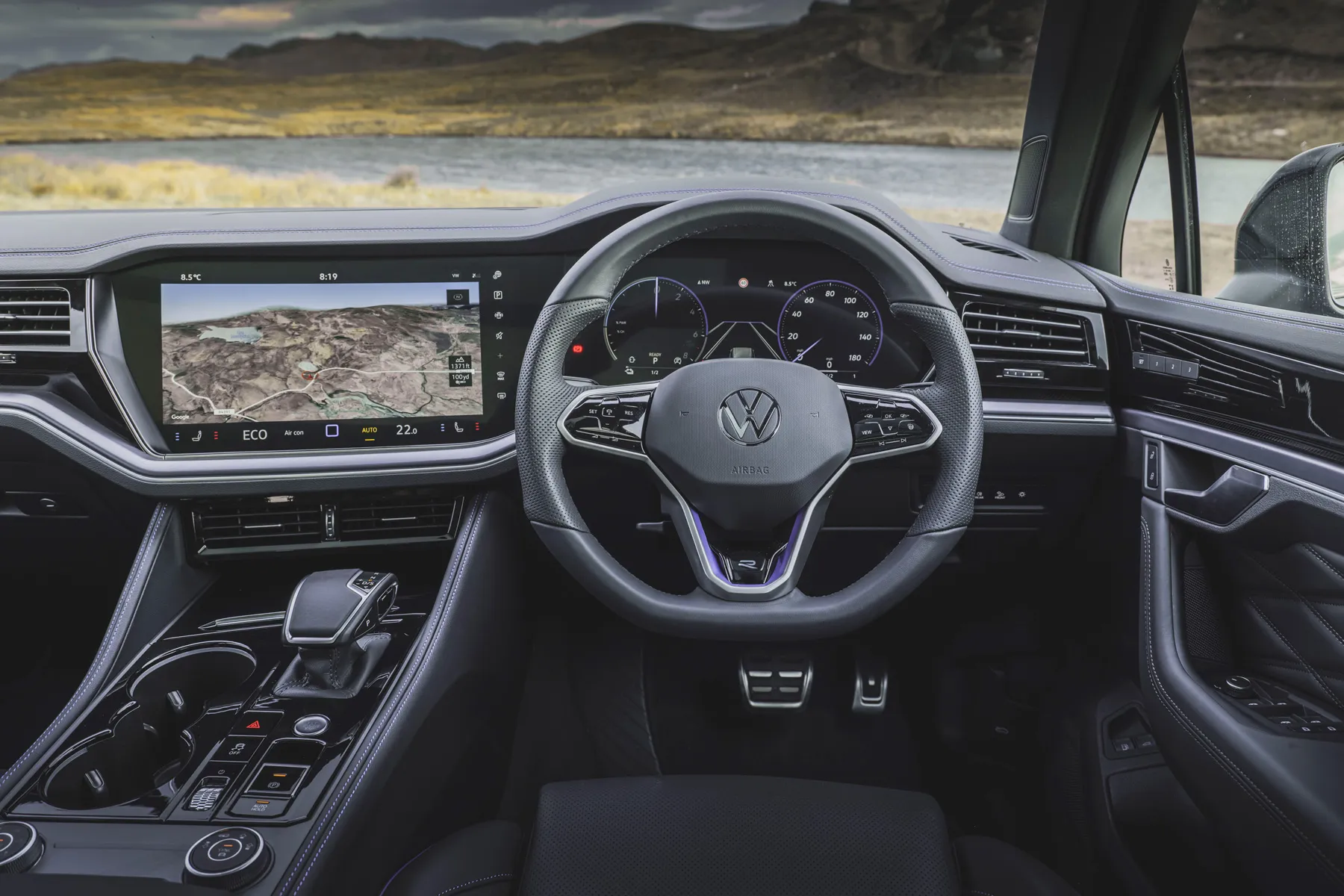 Interior view of a luxury Volkswagen dashboard featuring a large digital infotainment display.