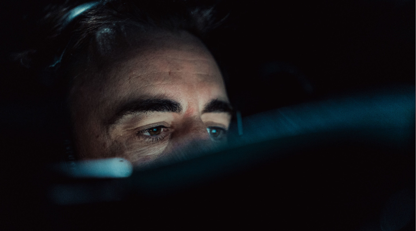 Fernando Alonso sitting in a high-tech F1 simulator.