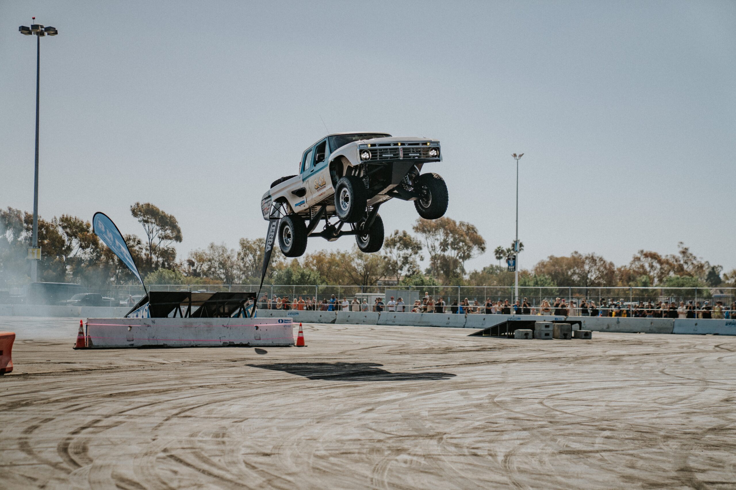 Crowds of enthusiasts walking through the outdoor vehicle displays at the Orange County Fairgrounds.