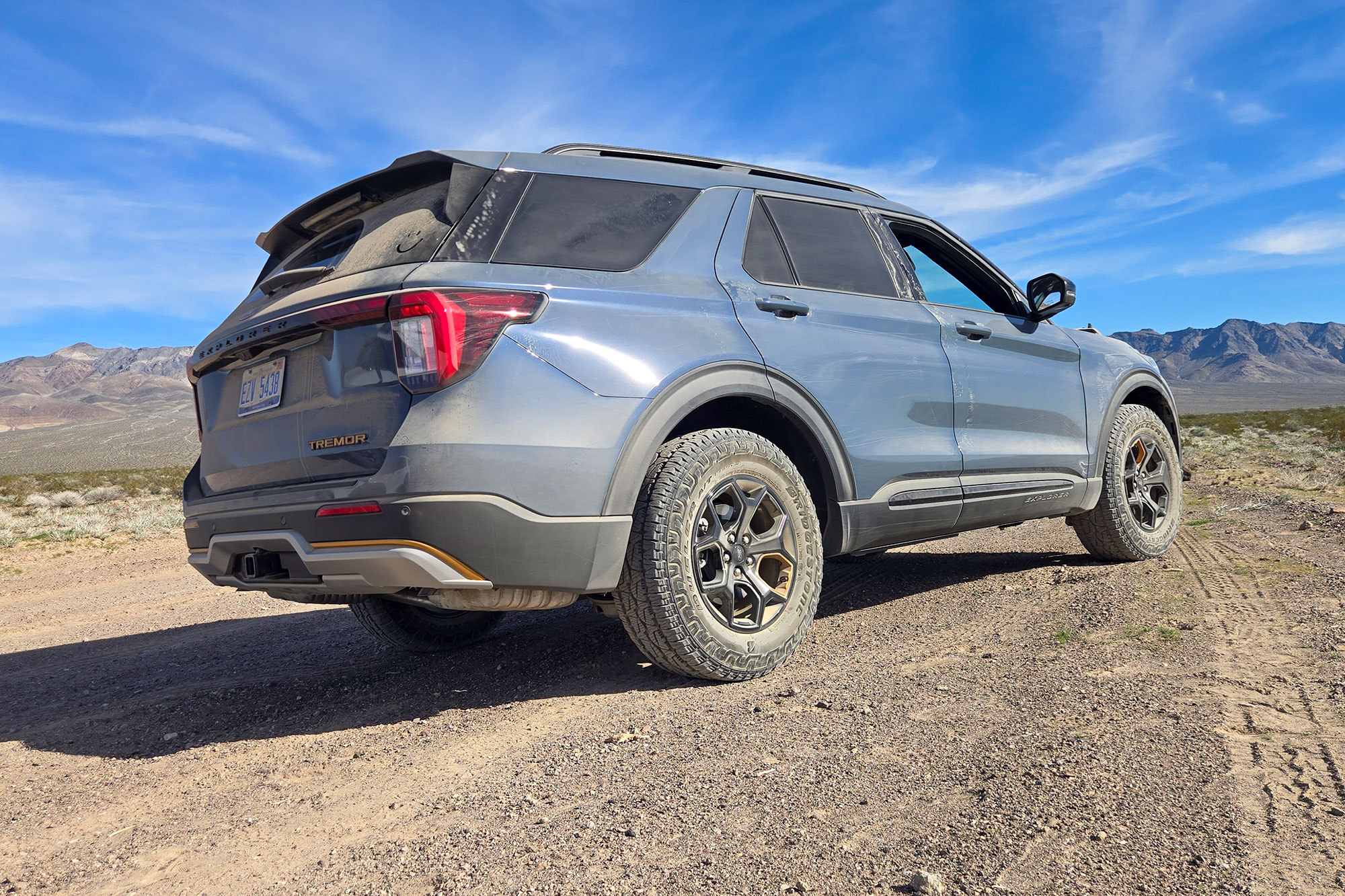 Rear view of the 2026 Ford Explorer Tremor parked on a mountain trail.