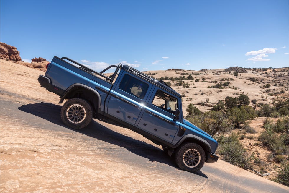 Ineos Grenadier 4x4 ascending a steep rocky slope on a desert trail in Moab.