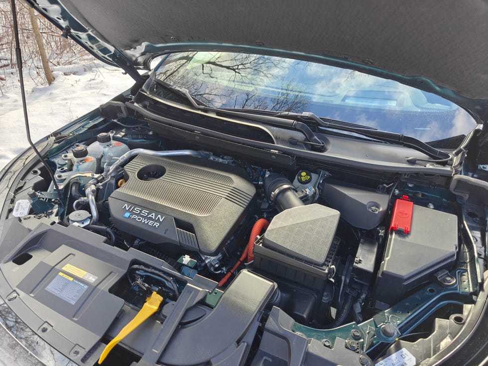 A Nissan Qashqai e-Power driving smoothly along a scenic winding road.