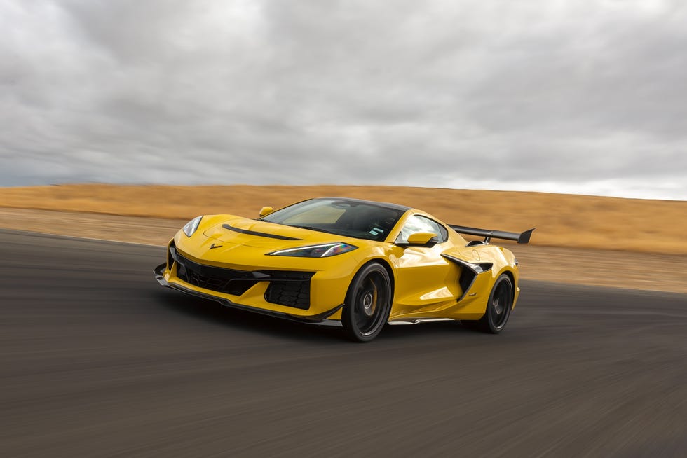 Yellow 2025 Chevrolet Corvette ZR1 cornering at high speed on a paved racing circuit.