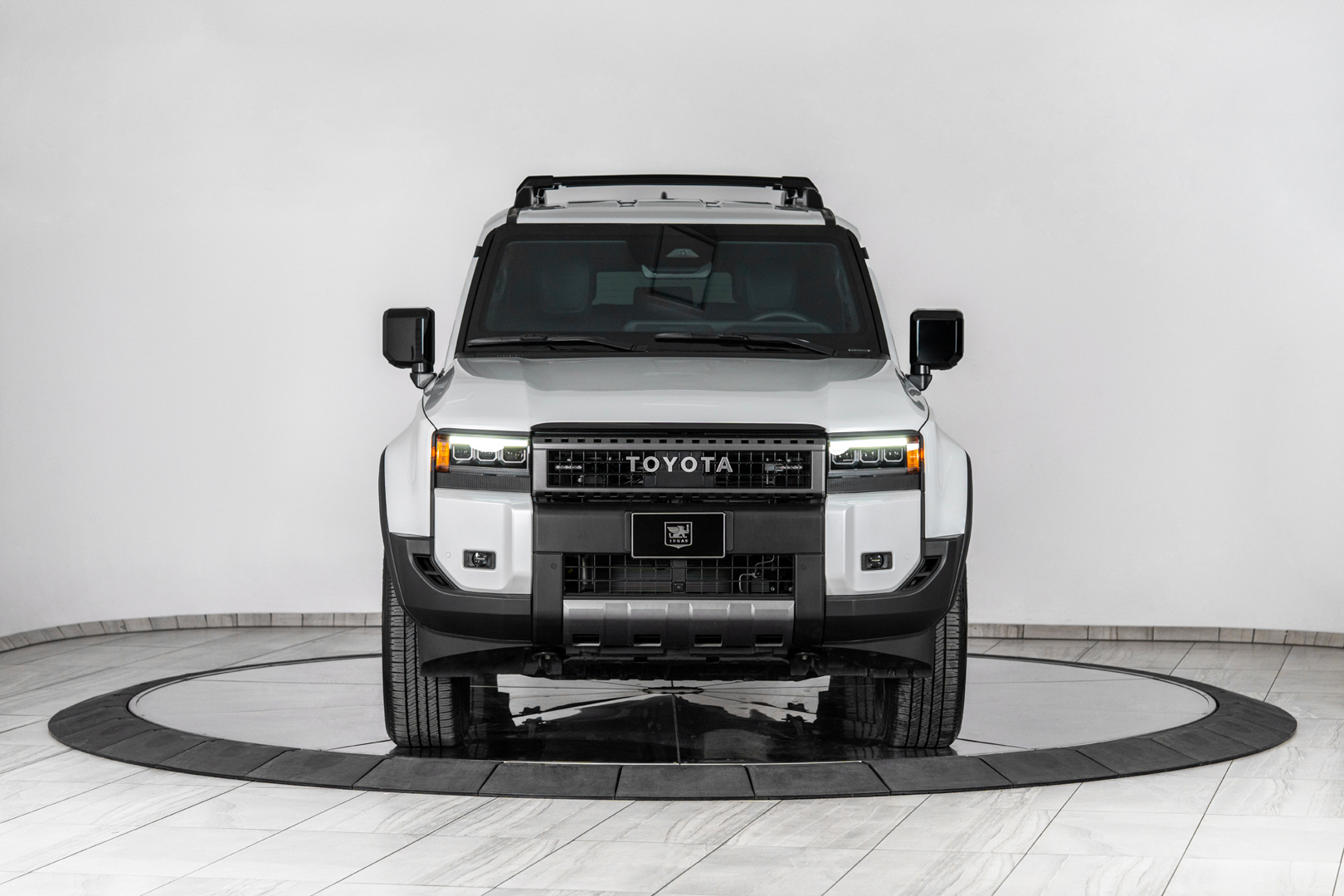 The luxurious front interior cockpit of an armored Land Cruiser showing standard controls and hidden security switches.