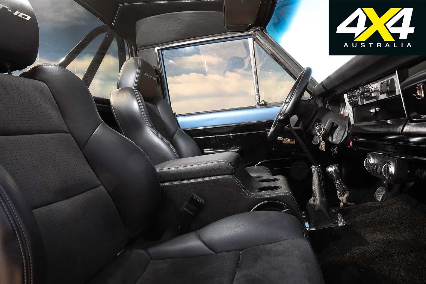 Interior view of the 1984 Jeep J10 featuring SRT10 leather seats and a Viper gauge cluster.