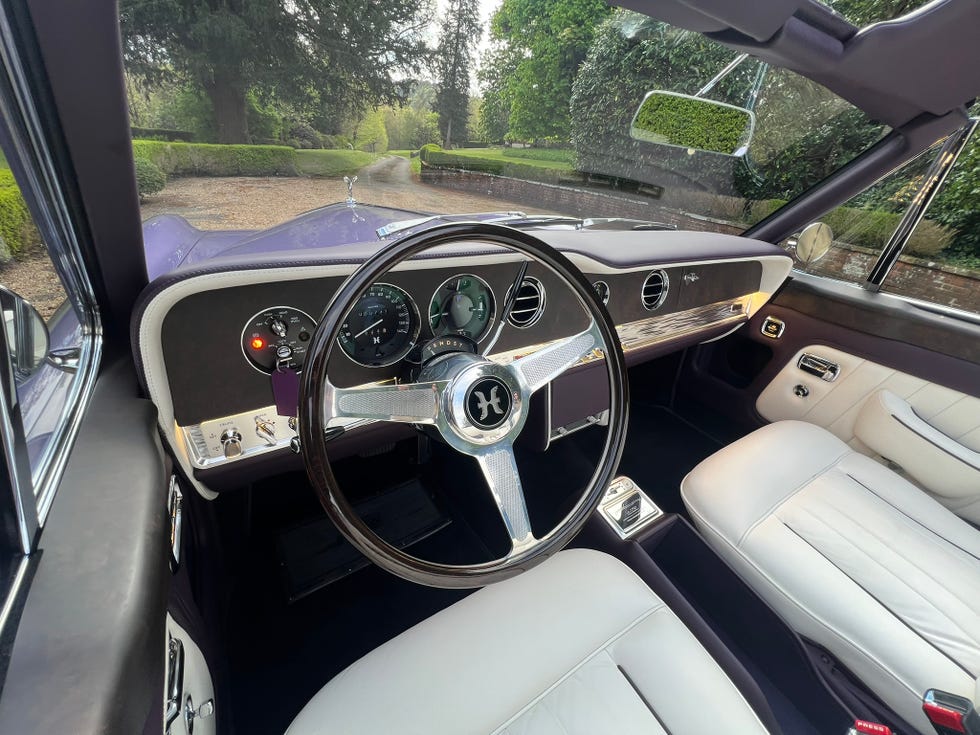 Luxurious interior of the remastered Rolls-Royce featuring wood veneers and classic gauges.